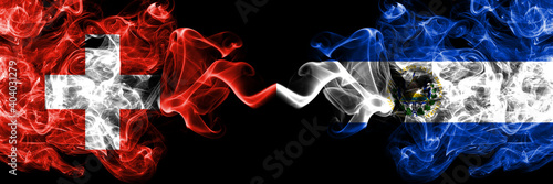 Switzerland, Swiss vs El Salvador, Salvadorian smoky mystic flags placed side by side. Thick colored silky abstract smoke flags.