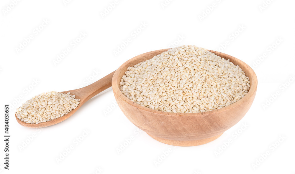 White sesame seeds in a wooden cup isolated on a white background White sesame seeds in a wooden cup isolated on a white background