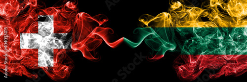 Switzerland  Swiss vs Lithuania  Lithuanian smoky mystic flags placed side by side. Thick colored silky abstract smoke flags.