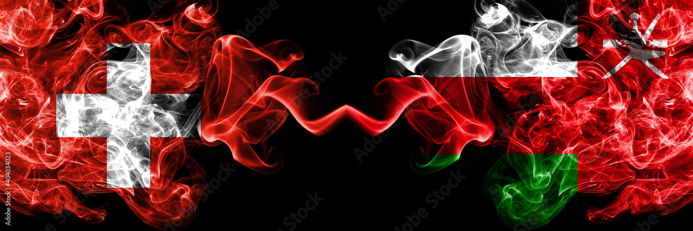 Switzerland, Swiss vs Oman smoky mystic flags placed side by side. Thick colored silky abstract smoke flags.