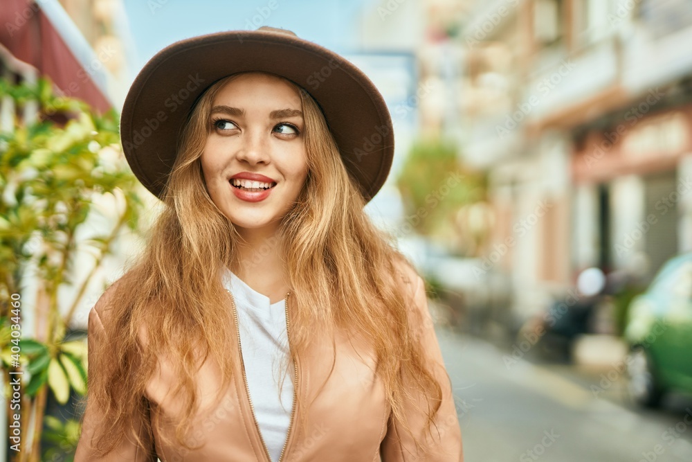Young blonde girl smiling happy standing at the city. Young blonde girl smiling happy standing at the city.