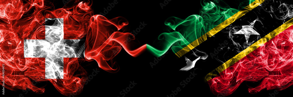 Switzerland, Swiss vs Saint Kitts and Nevis smoky mystic flags placed side by side. Thick colored silky abstract smoke flags. Switzerland, Swiss vs Saint Kitts and Nevis smoky mystic flags placed side by side. Thick colored silky abstract smoke flags.