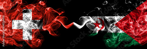 Switzerland  Swiss vs Sahrawi smoky mystic flags placed side by side. Thick colored silky abstract smoke flags.