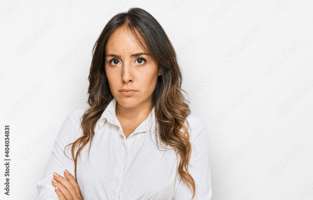 Young brunette woman wearing casual clothes skeptic and nervous, disapproving expression on face with crossed arms. negative person. Young brunette woman wearing casual clothes skeptic and nervous, disapproving expression on face with crossed arms. negative person.
