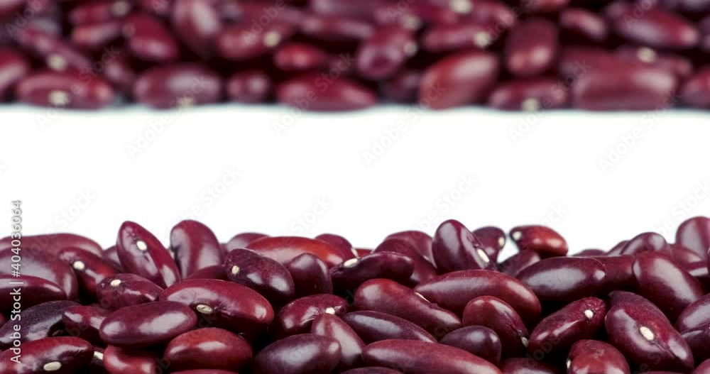 Track shot of raw red kidney beans texture pattern up and down on white background Track shot of raw red kidney beans texture pattern up and down on white background