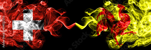 Switzerland, Swiss vs Wallonia smoky mystic flags placed side by side. Thick colored silky abstract smoke flags.