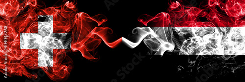 Switzerland  Swiss vs Yemen  Yemeni smoky mystic flags placed side by side. Thick colored silky abstract smoke flags.