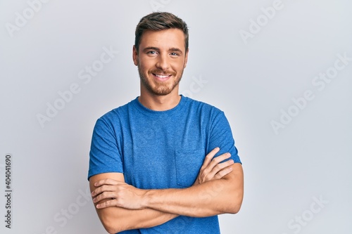 Handsome caucasian man wearing casual clothes happy face smiling with crossed arms looking at the camera. positive person.