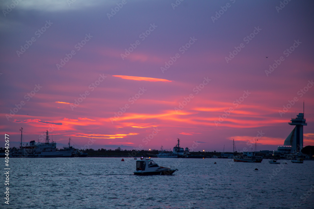 amazing sunset view colorful sky. boats and seagulls ready to sail