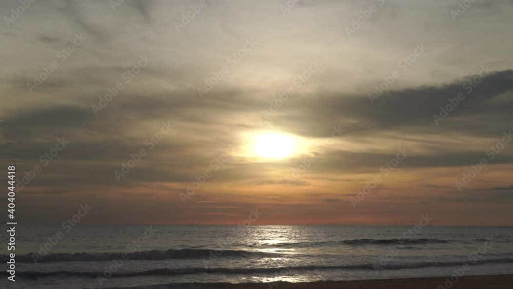 Natural videos and scenery the scene of the waves in the sea moving towards the coast, with the sun falling with gold reflected in the water At the Andaman Sea in Phuket 4K Resolution wide angle shot. Natural videos and scenery the scene of the waves in the sea moving towards the coast, with the sun falling with gold reflected in the water At the Andaman Sea in Phuket 4K Resolution wide angle shot.