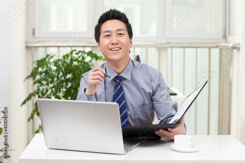 Close-up of a businessman using a laptop in an office