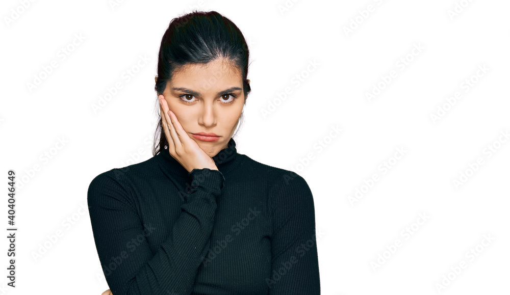 Young hispanic woman wearing casual clothes thinking looking tired and bored with depression problems with crossed arms. Young hispanic woman wearing casual clothes thinking looking tired and bored with depression problems with crossed arms.