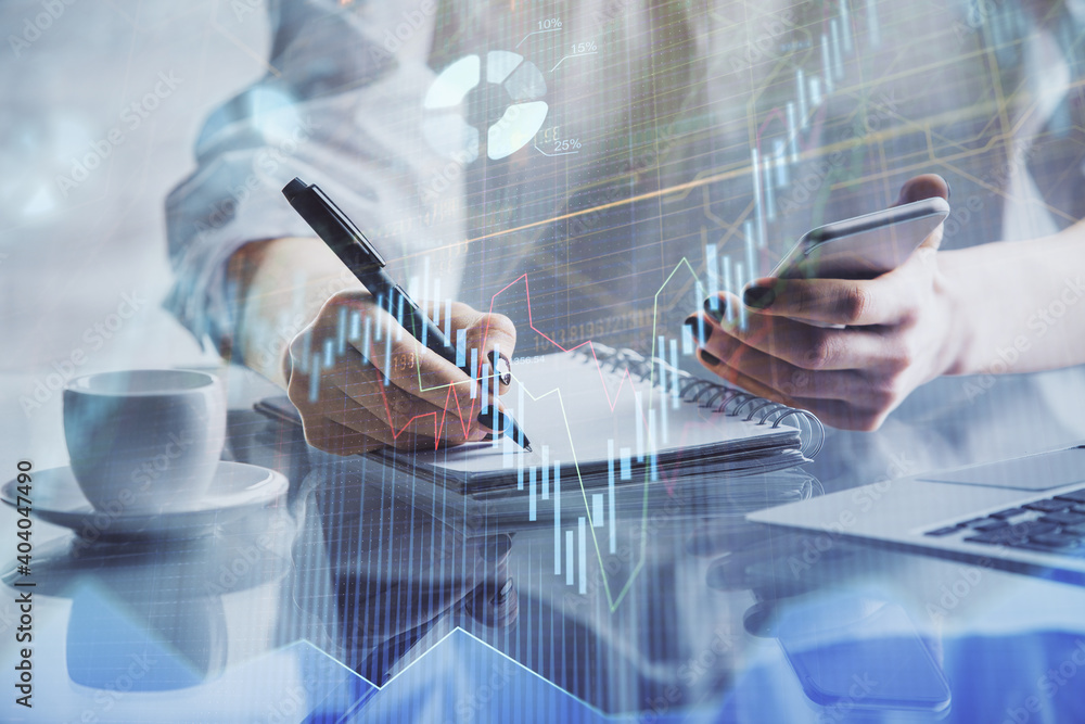 Double exposure of financial graph sketch hologram and woman holding and using a mobile device. Stock exchange concept. Double exposure of financial graph sketch hologram and woman holding and using a mobile device. Stock exchange concept.