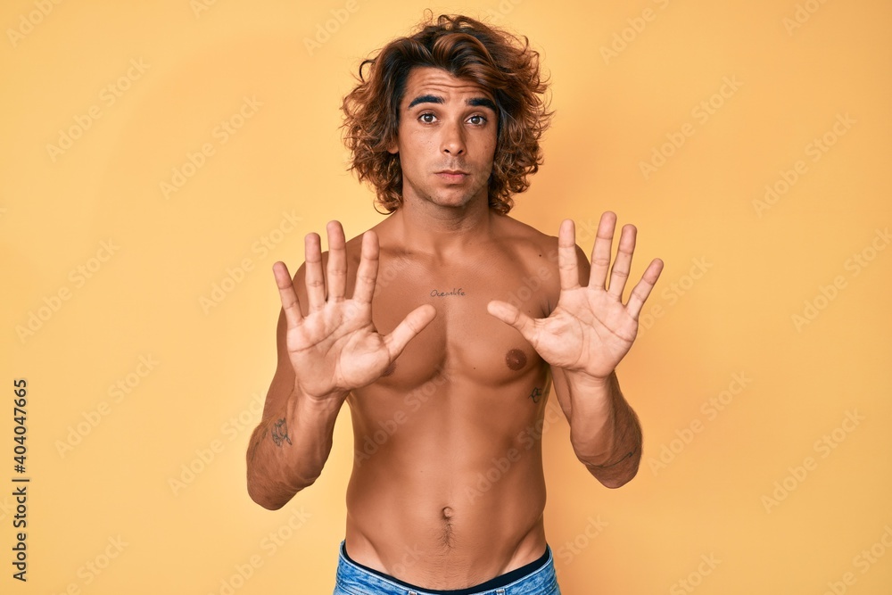 Ταπετσαρία Young hispanic man standing shirtless moving away hands palms showing refusal and denial with afraid and disgusting expression