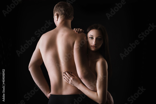 naked couple in lingerie guggs on black background. Sensual relationships