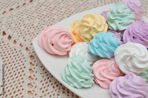 Close up of a plate with pastel colored meringues