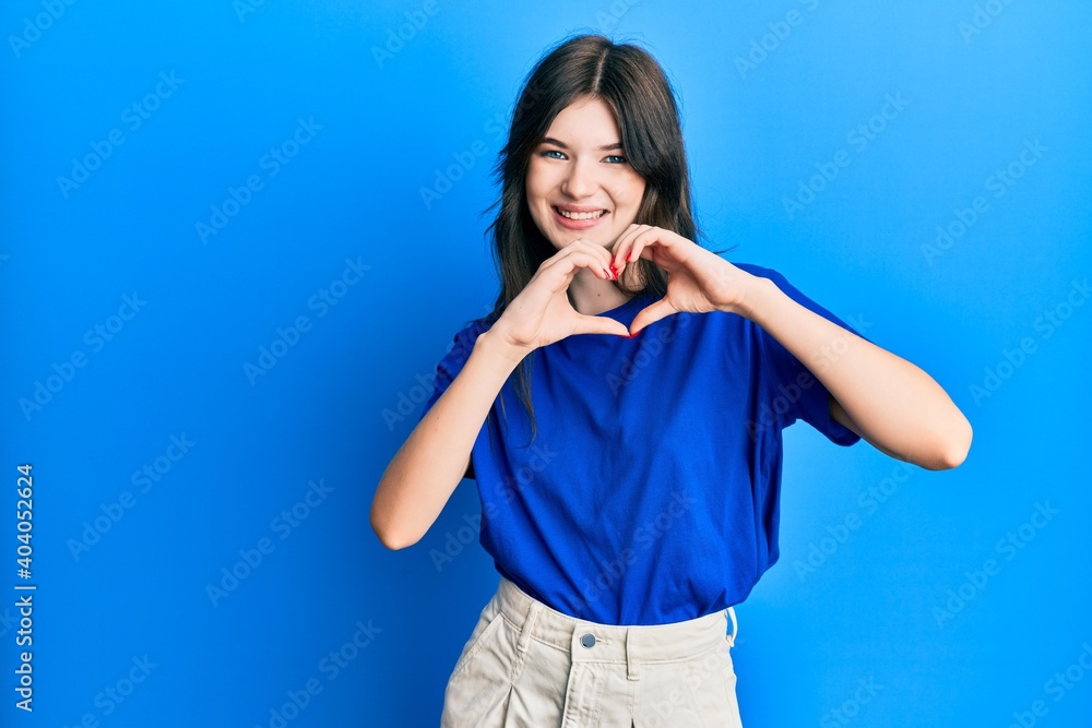 Young beautiful caucasian girl wearing casual clothes smiling in love doing heart symbol shape with hands. romantic concept. Young beautiful caucasian girl wearing casual clothes smiling in love doing heart symbol shape with hands. romantic concept.