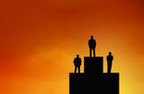 Silhouette of Businessman stand on winner stand , archievement , success and leadership concept.
