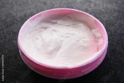 Close up of beauty cream in a pink container 