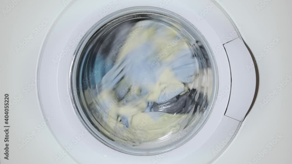 Linen is washed in the washing machine in the bathroom. The mechanism is moving Linen is washed in the washing machine in the bathroom. The mechanism is moving