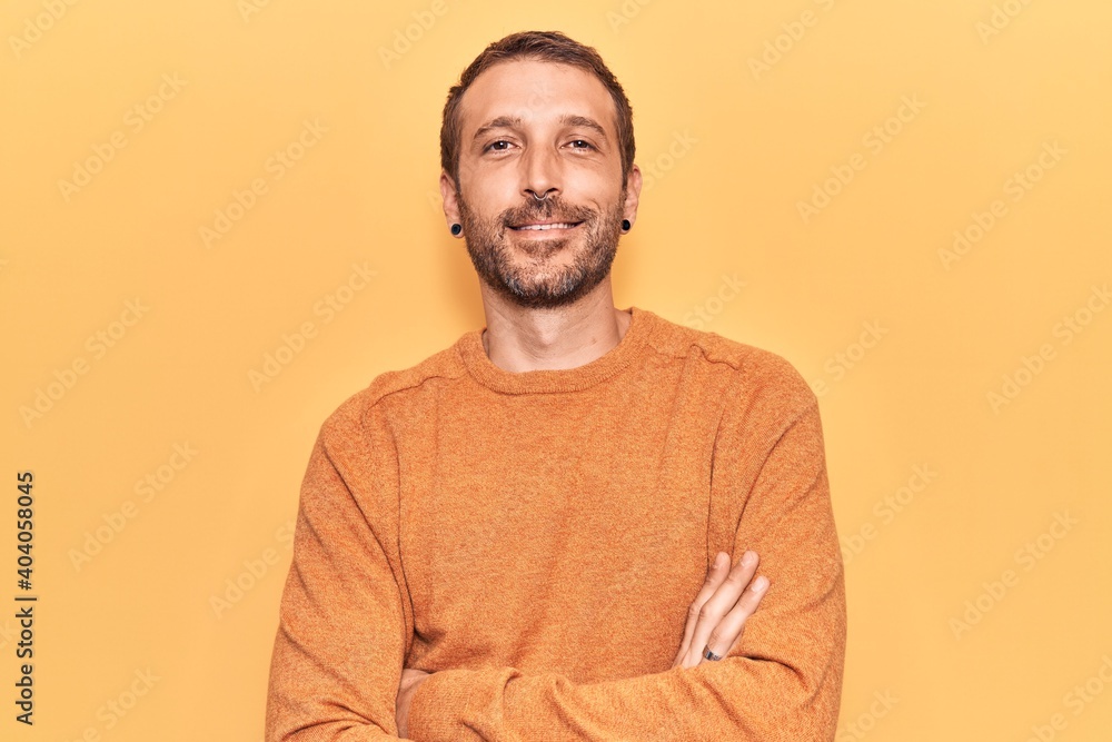 Young handsome man wearing casual clothes happy face smiling with crossed arms looking at the camera. positive person. Young handsome man wearing casual clothes happy face smiling with crossed arms looking at the camera. positive person.