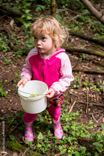 Cute blonde girl holding a bucket full of fresh shoots of sprout © anzebizjan