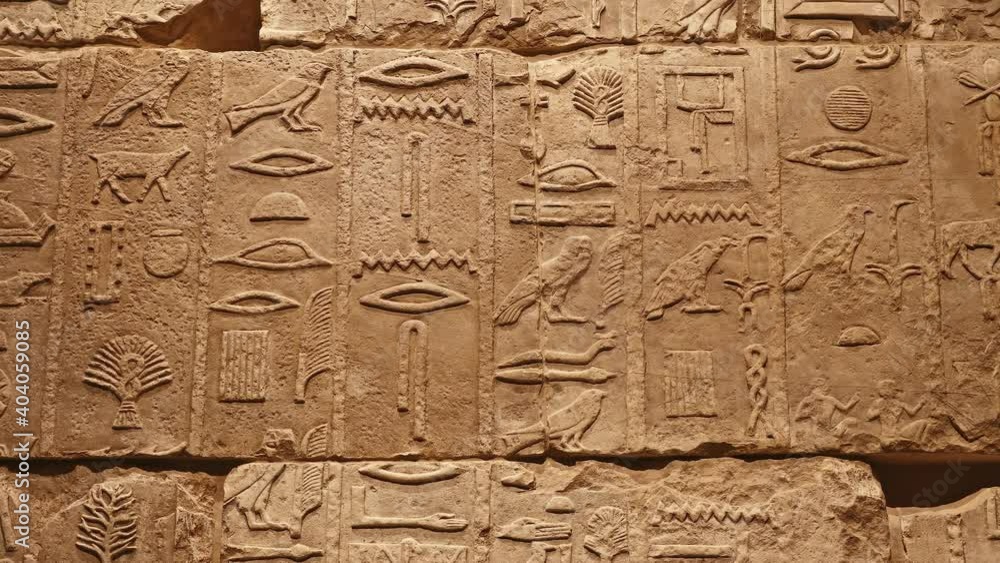 Stone wall with ancient Egyptian hieroglyphs Stone wall with ancient Egyptian hieroglyphs