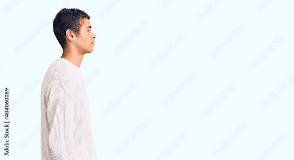 Young african amercian man wearing casual clothes looking to side, relax profile pose with natural face and confident smile. Young african amercian man wearing casual clothes looking to side, relax profile pose with natural face and confident smile.
