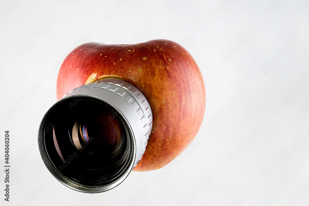 Apple fruit with lens, isolated, parody