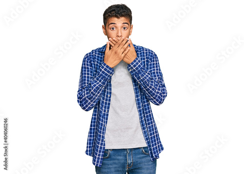 Young handsome african american man wearing casual clothes shocked covering mouth with hands for mistake. secret concept.