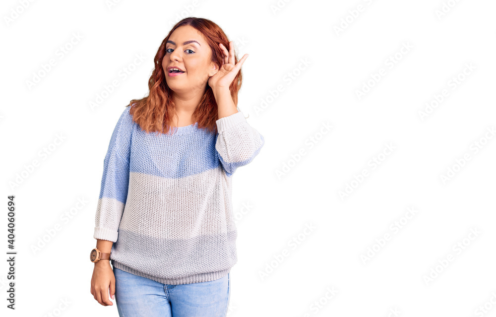 Young latin woman wearing casual clothes smiling with hand over ear listening an hearing to rumor or gossip. deafness concept. Young latin woman wearing casual clothes smiling with hand over ear listening an hearing to rumor or gossip. deafness concept.