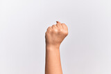 Hand of caucasian young woman doing protest and revolution gesture, fist expressing force and power