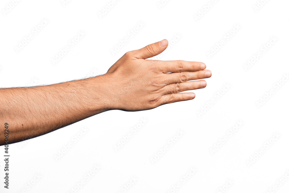 Hand of caucasian young man showing fingers over isolated white background stretching and reaching with open hand for handshake, showing back of the hand