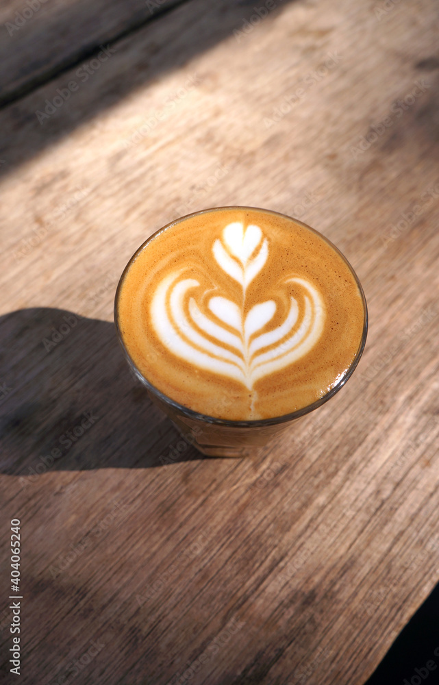 Hot latte coffee with heart shape latte art on dark brown old wood table at caff food and drink concept.
Hot latte coffee with heart shape latte art on dark brown old wood table at caff food and drink concept.