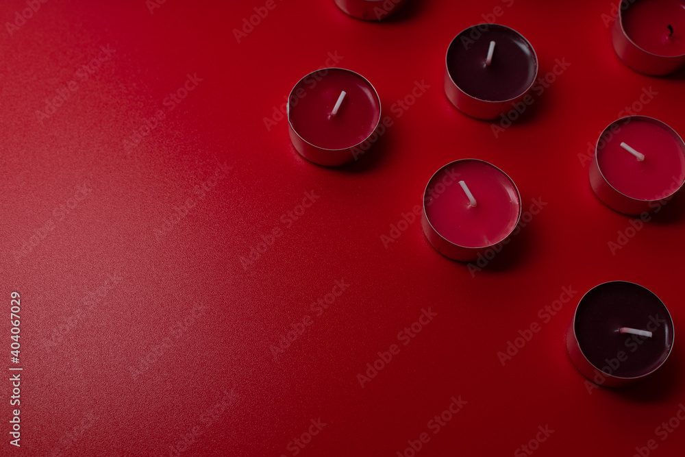 Red aroma candles on red background