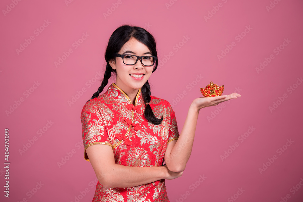 Action portrait beautiful Asian girl wearing Cheongsam red dress. the celebration of something in a joyful and exuberant way. Festivities and Celebration concept