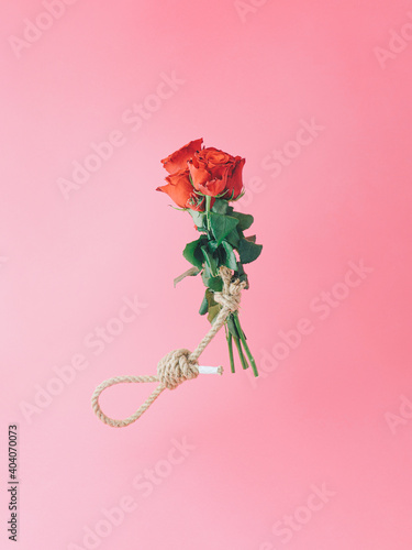Εκτύπωση καμβά Creative Valentines composition with tulip bouquet and hangmans noose against red background
