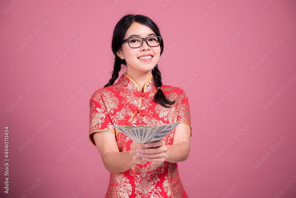 Action portrait beautiful Asian girl wearing Cheongsam red dress. the celebration of something in a joyful and exuberant way. Festivities and Celebration concept Action portrait beautiful Asian girl wearing Cheongsam red dress. the celebration of something in a joyful and exuberant way. Festivities and Celebration concept