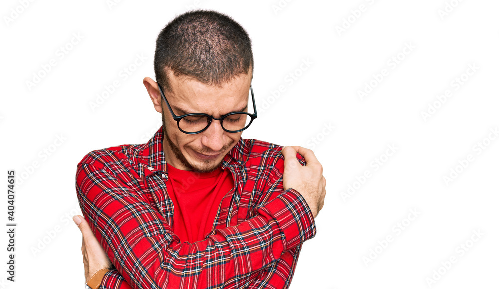 Naklejka premium Hispanic young man wearing casual clothes hugging oneself happy and positive, smiling confident. self love and self care
