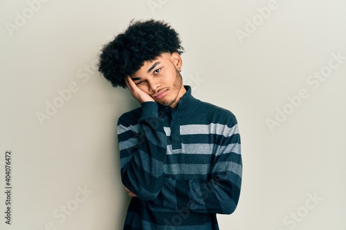 Young african american man with afro hair wearing casual clothes thinking looking tired and bored with depression problems with crossed arms. © Krakenimages.com