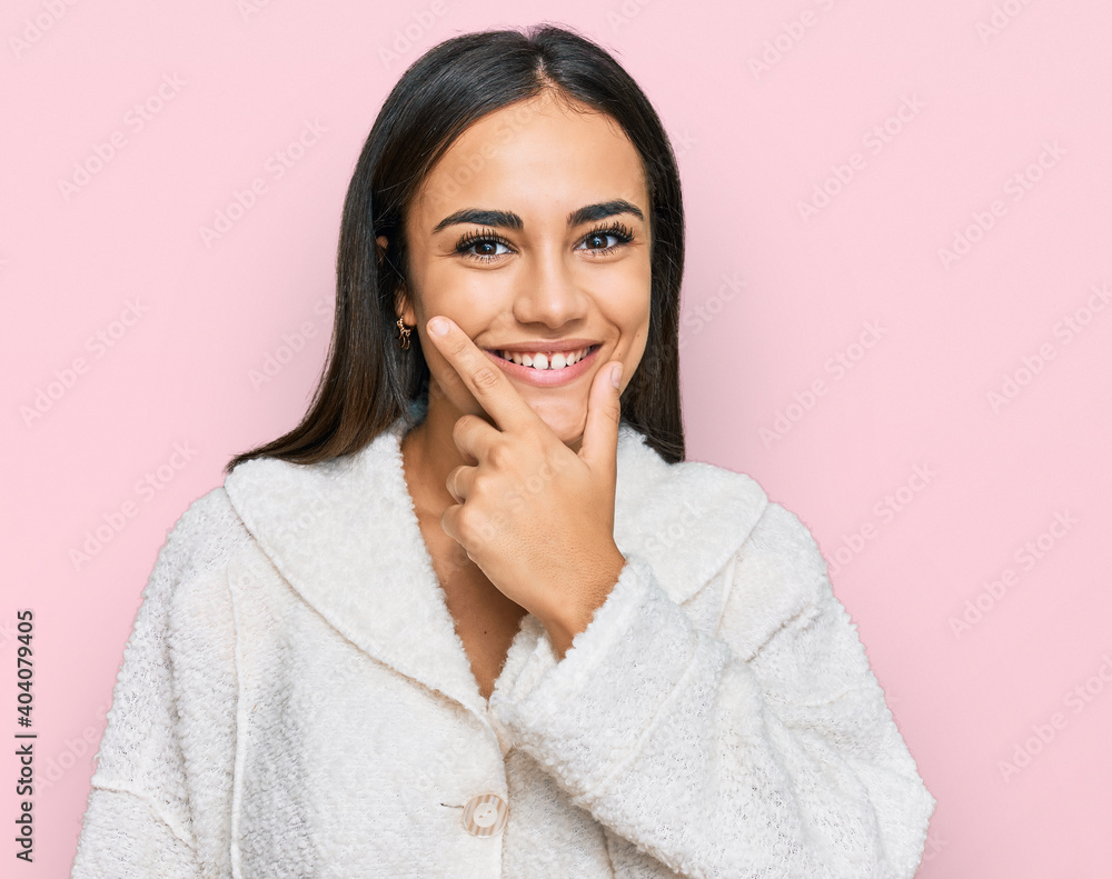 Young brunette woman wearing casual clothes looking confident at the camera smiling with crossed arms and hand raised on chin. thinking positive. Young brunette woman wearing casual clothes looking confident at the camera smiling with crossed arms and hand raised on chin. thinking positive.