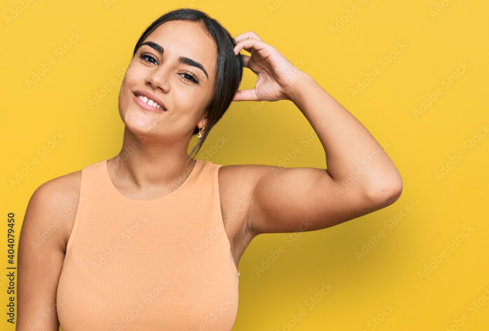 Fototapeta premium Young brunette woman wearing casual clothes confuse and wonder about question. uncertain with doubt, thinking with hand on head. pensive concept.