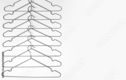Metal clothes hangers on a light background. Wardrobes were hung for clothes. Place for text