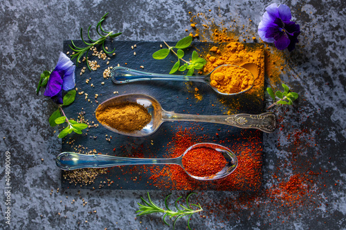 A black board with colourful spices arranged for cooking. Copy Space. photo