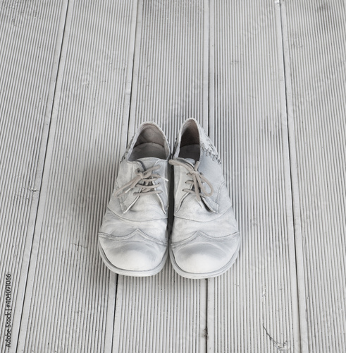 white mens shoes on white wooden floor