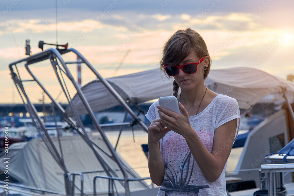 Young caucasian woman sailor enjoying summertime.