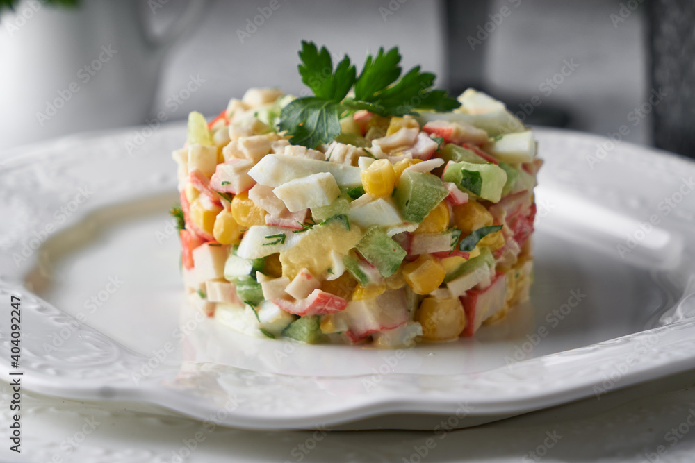 crab stick salad served in white plate on grey stone table Healthy food