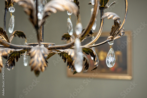 close up detail of crystal pendant chandelier, selective focus, blurred background