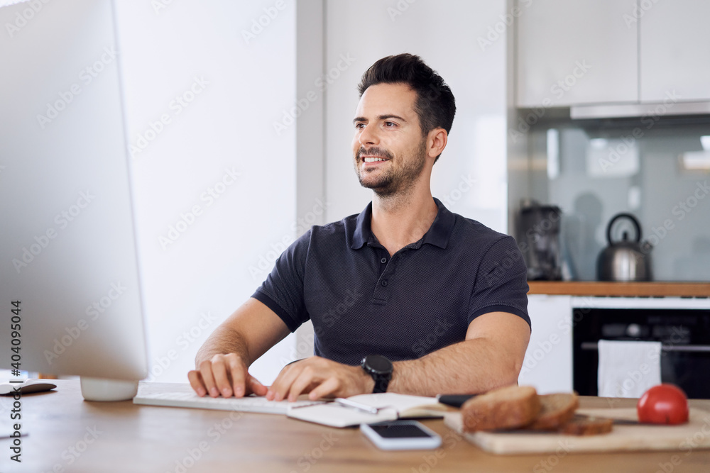 Casual man working from home using computer Casual man working from home using computer