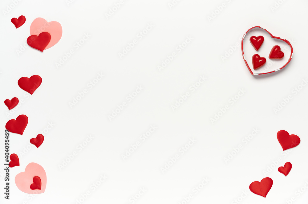 Saint Valentine concept, top view of colored hearts and candy inside gift box on white isolated with place for text background